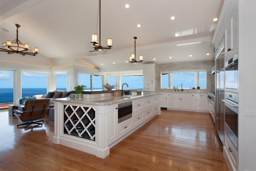 Huge arts and crafts l-shaped light wood floor and beige floor eat-in kitchen photo in Los Angeles with an undermount sink, shaker cabinets, white cabinets, quartzite countertops, white backsplash, stone slab backsplash, stainless steel appliances and an island