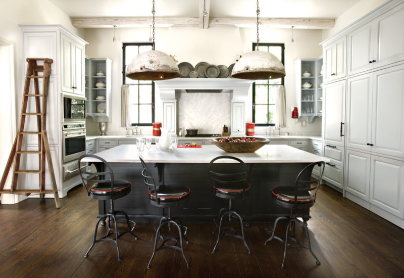 Kitchen - transitional u-shaped kitchen idea in Atlanta with raised-panel cabinets, white cabinets, white backsplash, stone slab backsplash and paneled appliances