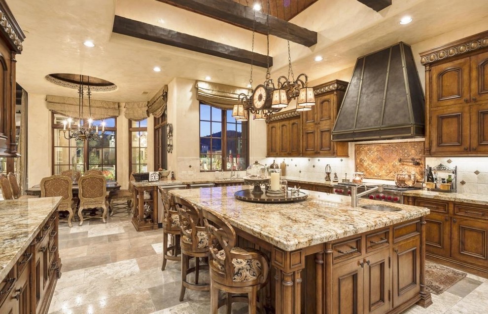 Large tuscan u-shaped travertine floor eat-in kitchen photo in Phoenix with a double-bowl sink, recessed-panel cabinets, dark wood cabinets, white backsplash, porcelain backsplash, stainless steel appliances and an island