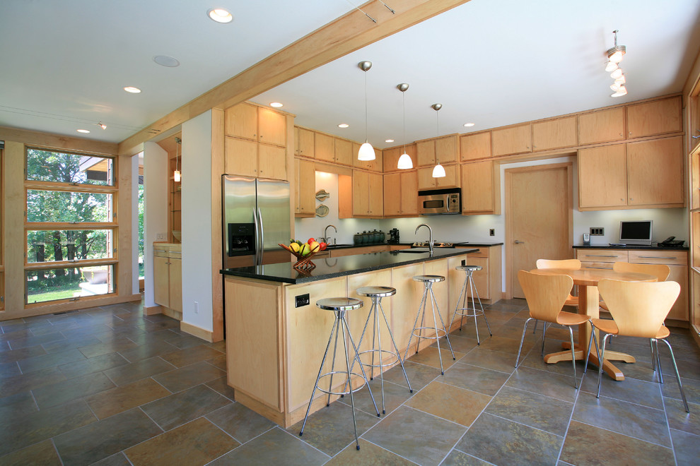Contemporary l-shaped kitchen in Other with flat-panel cabinets and light wood cabinets.