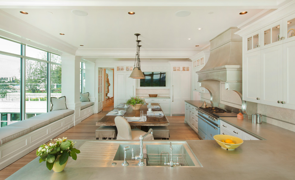 Example of a transitional l-shaped eat-in kitchen design in Omaha with colored appliances, an integrated sink, shaker cabinets and white cabinets