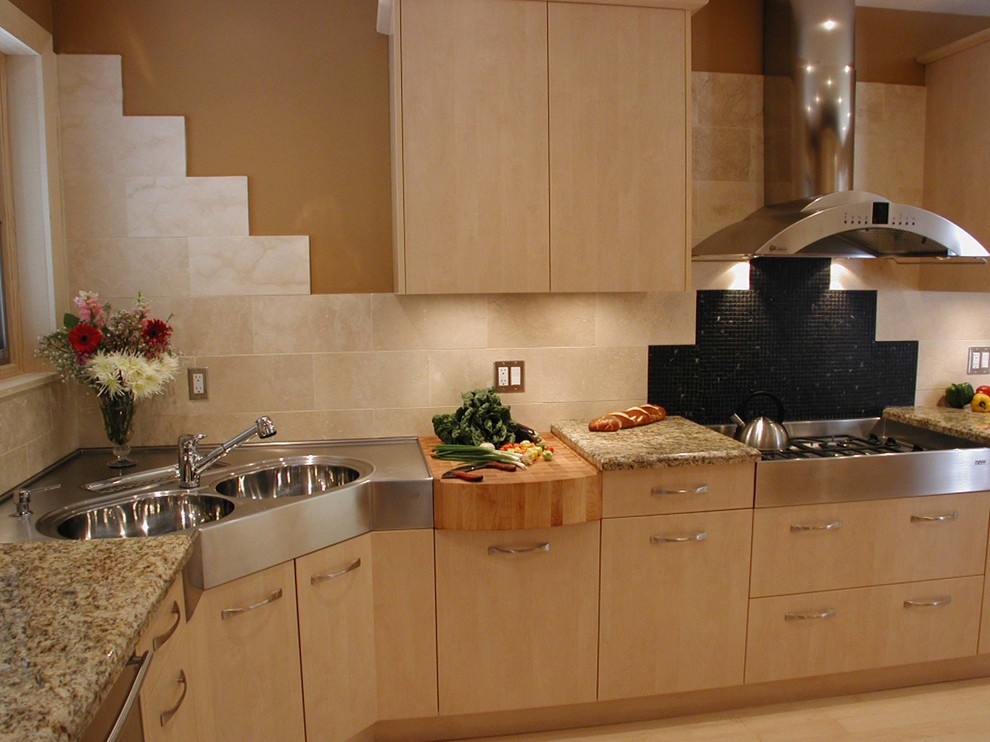 This is an example of a small contemporary single-wall enclosed kitchen in Other with a double-bowl sink, flat-panel cabinets, light wood cabinets, granite worktops, beige splashback, porcelain splashback, stainless steel appliances, light hardwood flooring and no island.