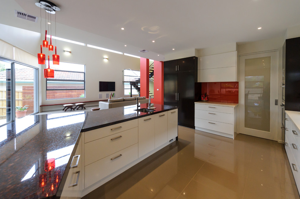 Design ideas for a large contemporary kitchen in Melbourne with flat-panel cabinets, yellow cabinets, granite worktops, red splashback, glass sheet splashback, porcelain flooring and an island.