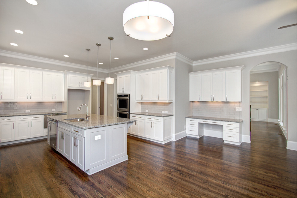Large transitional u-shaped dark wood floor eat-in kitchen photo in Charlotte with an undermount sink, shaker cabinets, white cabinets, granite countertops, gray backsplash, ceramic backsplash, stainless steel appliances and an island