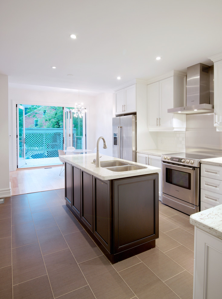 Small trendy l-shaped ceramic tile eat-in kitchen photo in Toronto with an undermount sink, beaded inset cabinets, white cabinets, solid surface countertops, white backsplash, subway tile backsplash, stainless steel appliances and an island