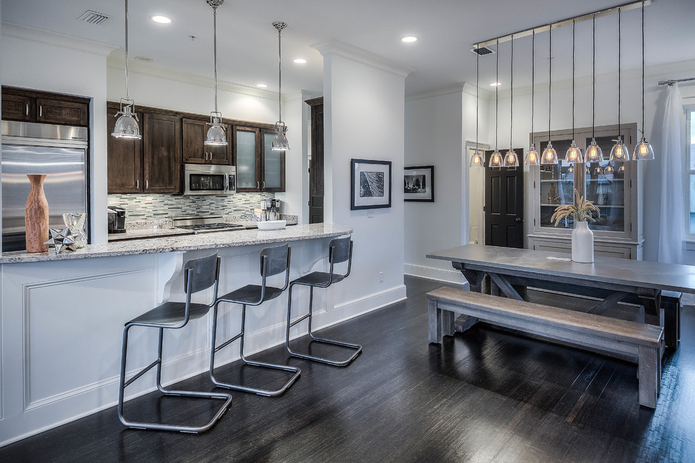 Example of a mid-sized transitional galley dark wood floor and brown floor open concept kitchen design in Atlanta with a double-bowl sink, shaker cabinets, dark wood cabinets, granite countertops, multicolored backsplash, matchstick tile backsplash, stainless steel appliances and a peninsula