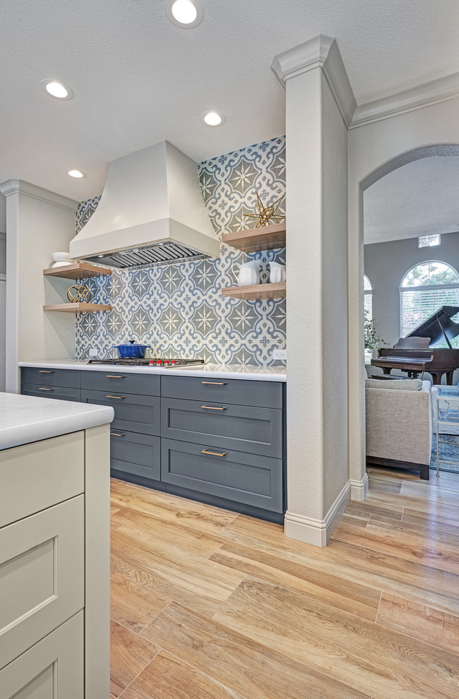 Example of a large transitional l-shaped porcelain tile and beige floor eat-in kitchen design in Sacramento with an undermount sink, recessed-panel cabinets, blue cabinets, quartz countertops, gray backsplash, ceramic backsplash, stainless steel appliances, an island and white countertops