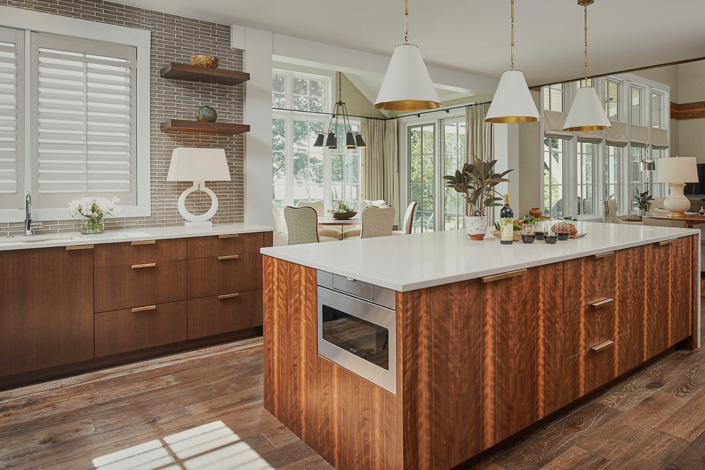 Inspiration for a large transitional l-shaped dark wood floor open concept kitchen remodel in Grand Rapids with an undermount sink, flat-panel cabinets, dark wood cabinets, granite countertops, brown backsplash, subway tile backsplash, stainless steel appliances and an island