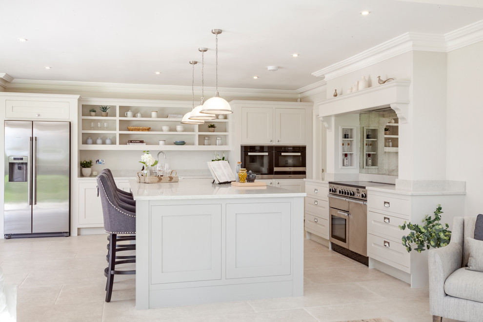 Country l-shaped kitchen in Hampshire with shaker cabinets, grey cabinets, stainless steel appliances, an island, beige floors and white worktops.