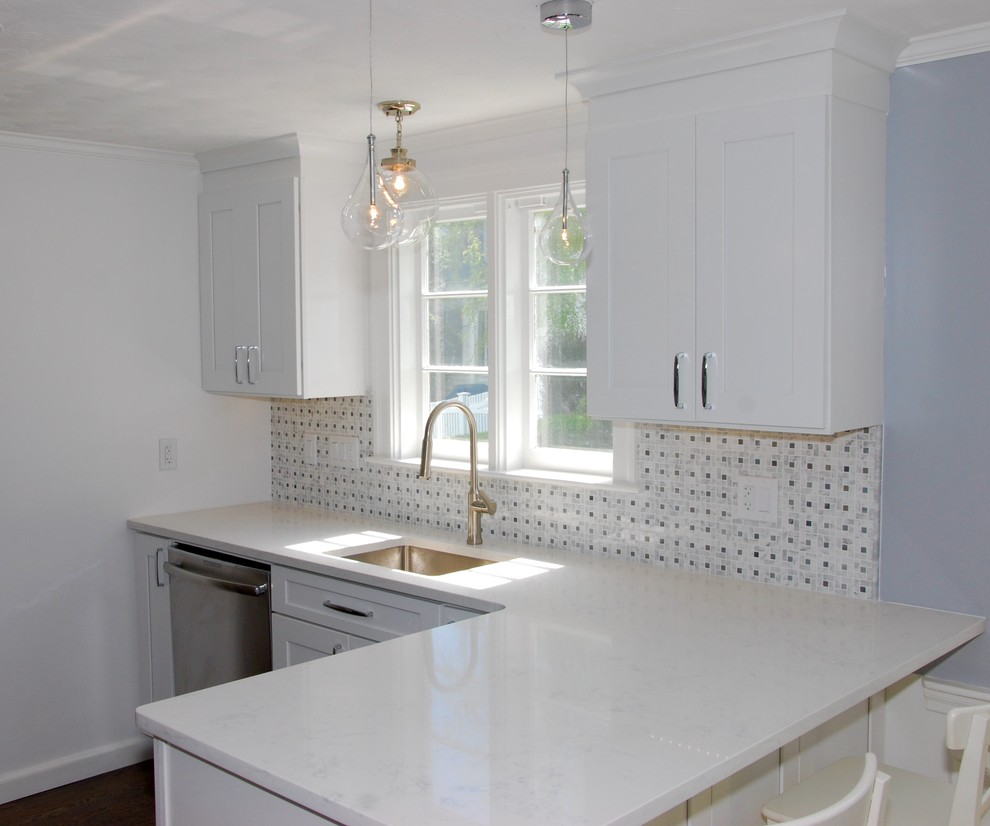 Photo of a small classic l-shaped kitchen in Boston with white cabinets, a submerged sink, recessed-panel cabinets, quartz worktops and stainless steel appliances.