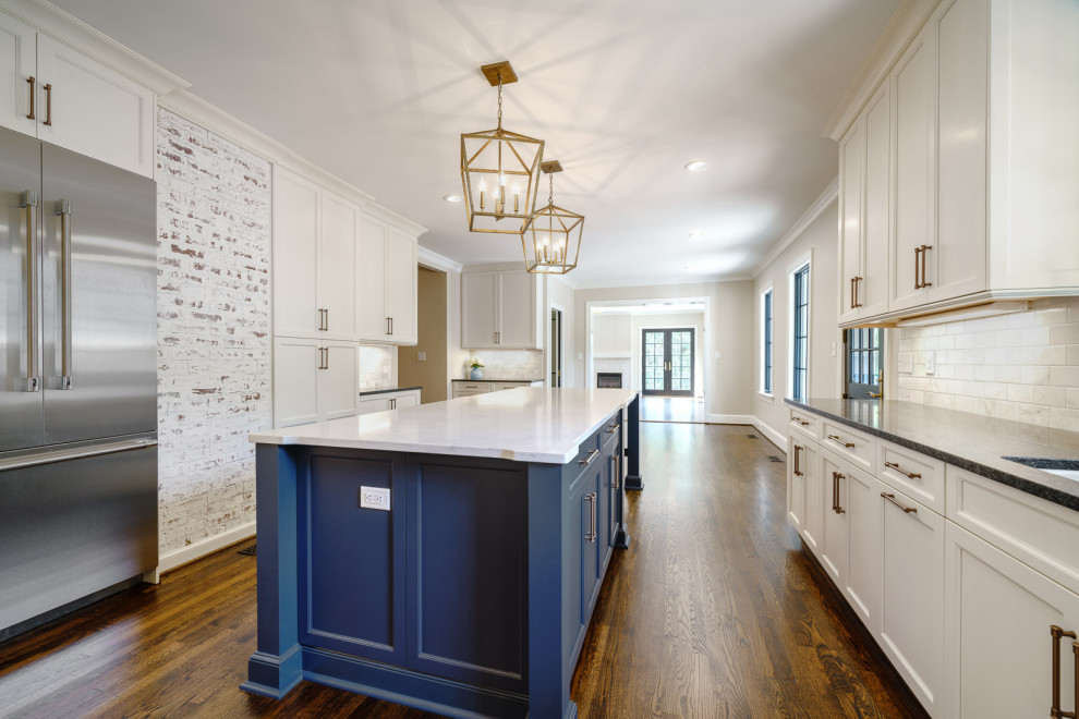 Example of a large classic galley dark wood floor and brown floor eat-in kitchen design in Other with a single-bowl sink, flat-panel cabinets, blue cabinets, quartz countertops, white backsplash, marble backsplash, stainless steel appliances, an island and white countertops