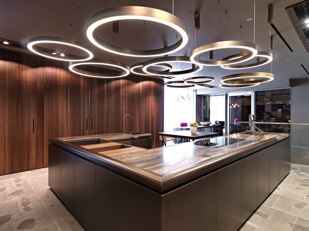 Large contemporary u-shaped open plan kitchen in London with flat-panel cabinets and marble worktops.