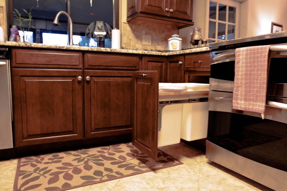 Example of a mid-sized classic u-shaped eat-in kitchen design in Orlando with raised-panel cabinets, medium tone wood cabinets, granite countertops, beige backsplash, stone tile backsplash and a peninsula