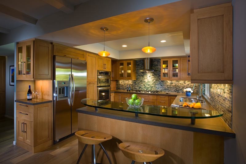 Inspiration for a large transitional u-shaped light wood floor eat-in kitchen remodel in Orange County with a double-bowl sink, flat-panel cabinets, light wood cabinets, glass countertops, multicolored backsplash, mosaic tile backsplash, stainless steel appliances and no island