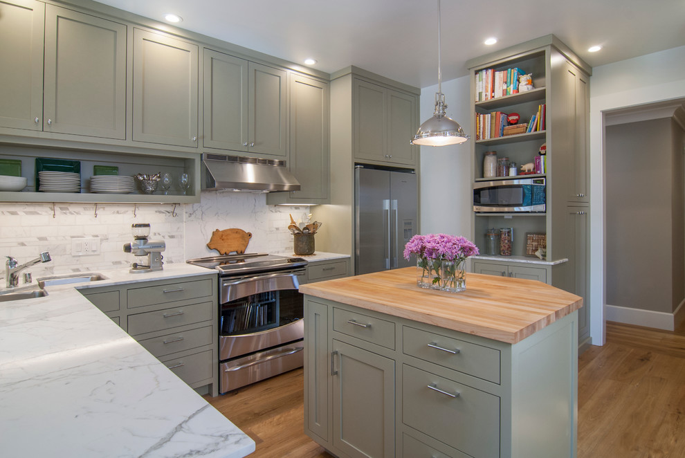 Small elegant l-shaped light wood floor eat-in kitchen photo in San Francisco with an undermount sink, shaker cabinets, gray cabinets, marble countertops, white backsplash, stone tile backsplash, stainless steel appliances and an island