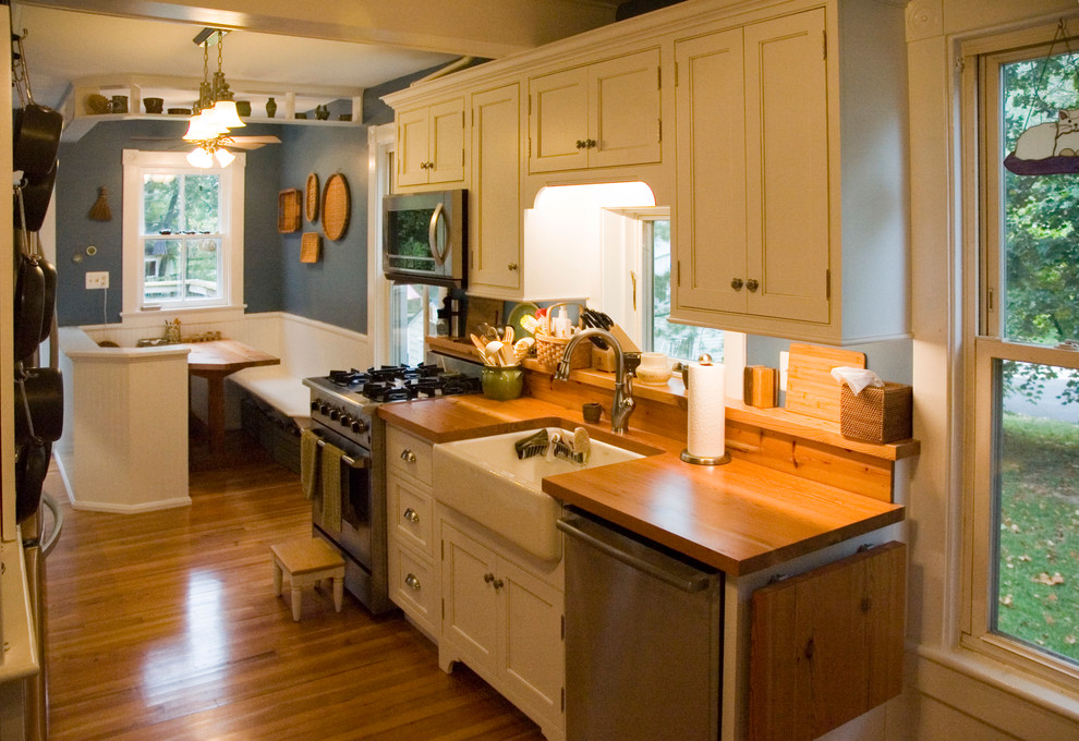 Design ideas for a small farmhouse galley kitchen/diner in DC Metro with a belfast sink, beaded cabinets, white cabinets, wood worktops, stainless steel appliances, medium hardwood flooring and no island.