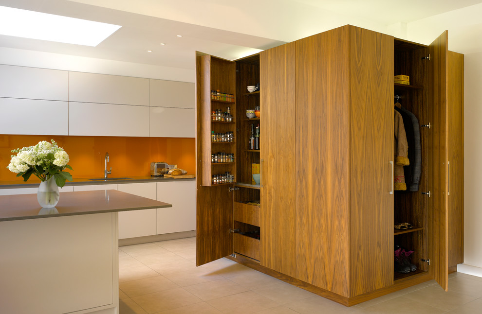 Inspiration for a large contemporary open plan kitchen in London with white cabinets.