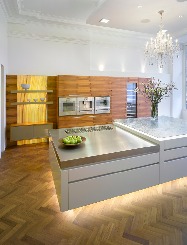 Inspiration for a large contemporary medium tone wood floor open concept kitchen remodel in London with flat-panel cabinets, medium tone wood cabinets, quartzite countertops, stainless steel appliances and an island