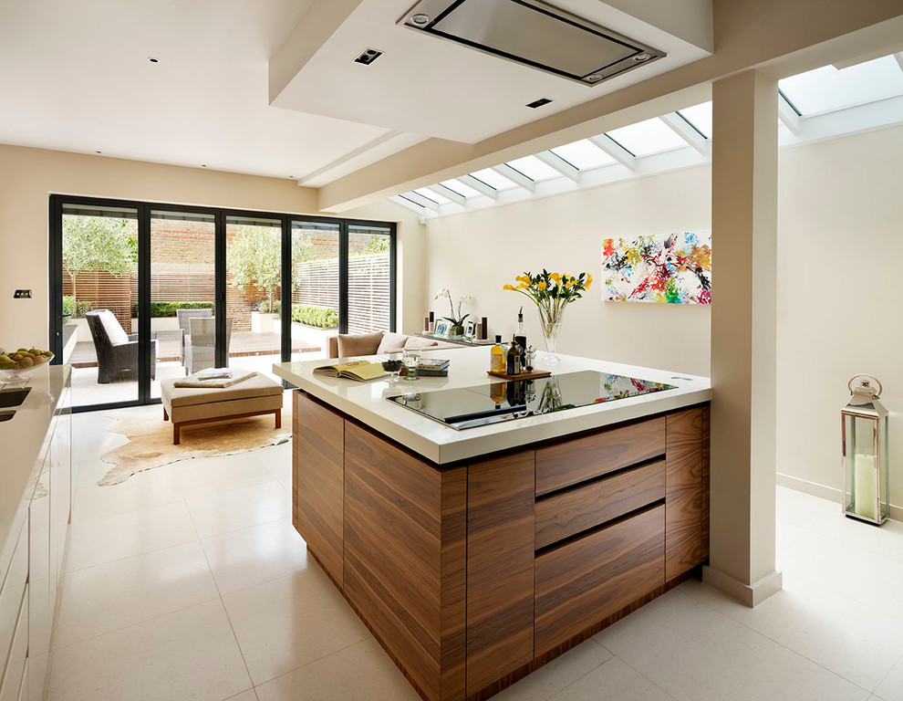 Large contemporary grey and cream open plan kitchen in London with flat-panel cabinets, medium wood cabinets, composite countertops and an island.