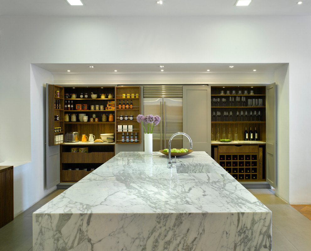 Example of a large trendy open concept kitchen design in London with an integrated sink, recessed-panel cabinets, gray cabinets, marble countertops and stainless steel appliances