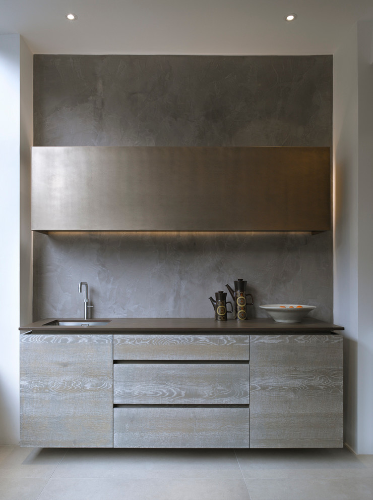 Inspiration for a large contemporary kitchen/diner in London with a submerged sink, flat-panel cabinets, grey cabinets, composite countertops and ceramic splashback.