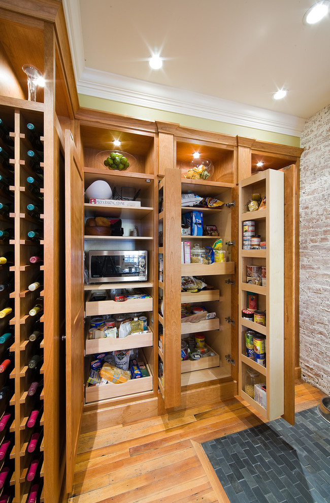 Photo of a large rustic u-shaped kitchen/diner in Bridgeport with a submerged sink, shaker cabinets, medium wood cabinets, granite worktops, brown splashback, brick splashback, stainless steel appliances, medium hardwood flooring, a breakfast bar and brown floors.