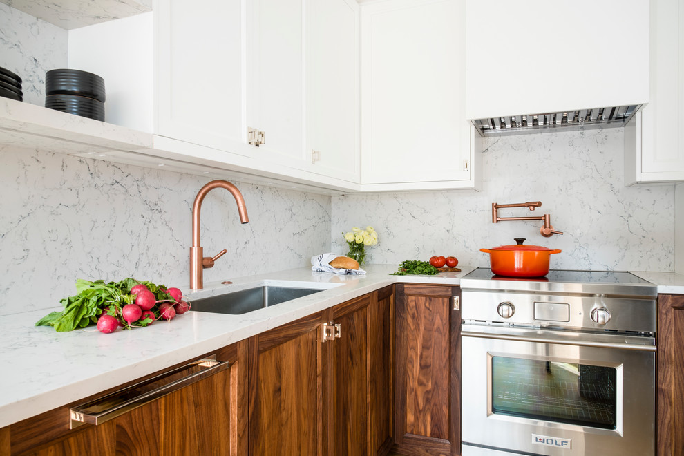 Kitchen - small transitional kitchen idea in Boston with an undermount sink, shaker cabinets, dark wood cabinets, white backsplash, stone slab backsplash and stainless steel appliances