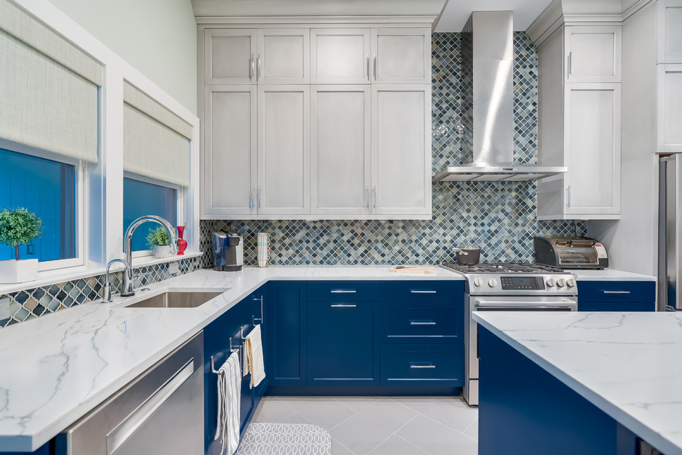 Inspiration for a medium sized contemporary l-shaped kitchen/diner in DC Metro with a submerged sink, blue cabinets, engineered stone countertops, multi-coloured splashback, ceramic splashback, stainless steel appliances, porcelain flooring, an island, grey floors, white worktops and shaker cabinets.