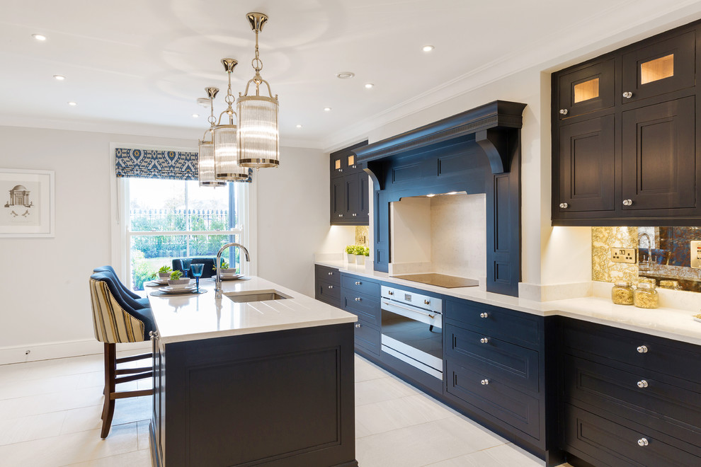 This is an example of a traditional kitchen in Other with black cabinets, an island and white worktops.