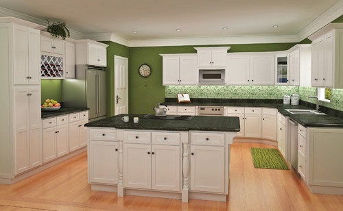 White RTA kitchen cabinets with green walls, black countertops, and a large center island in a modern spacious kitchen