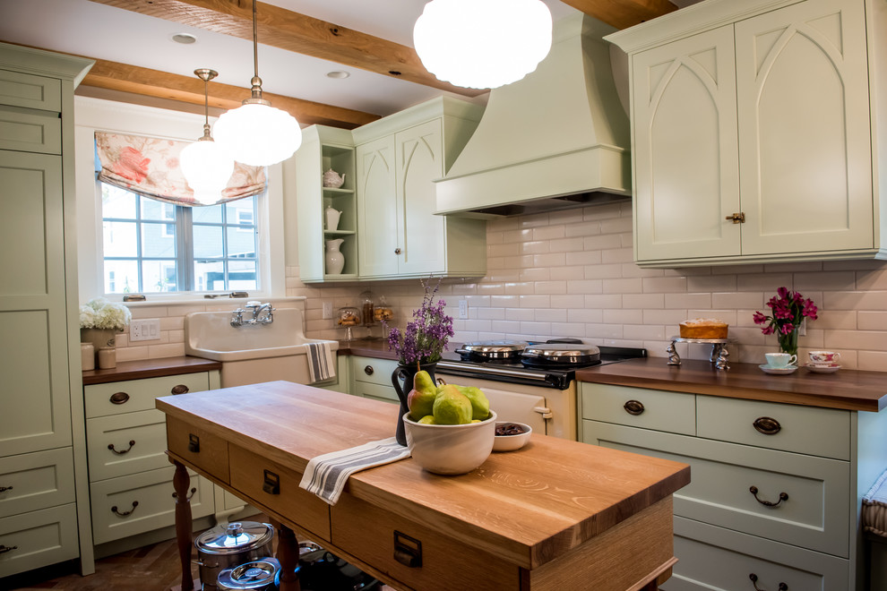 Foto på ett avskilt lantligt l-kök, med en rustik diskho, luckor med infälld panel, gröna skåp, träbänkskiva, vitt stänkskydd, stänkskydd i porslinskakel, färgglada vitvaror, klinkergolv i porslin och en köksö
