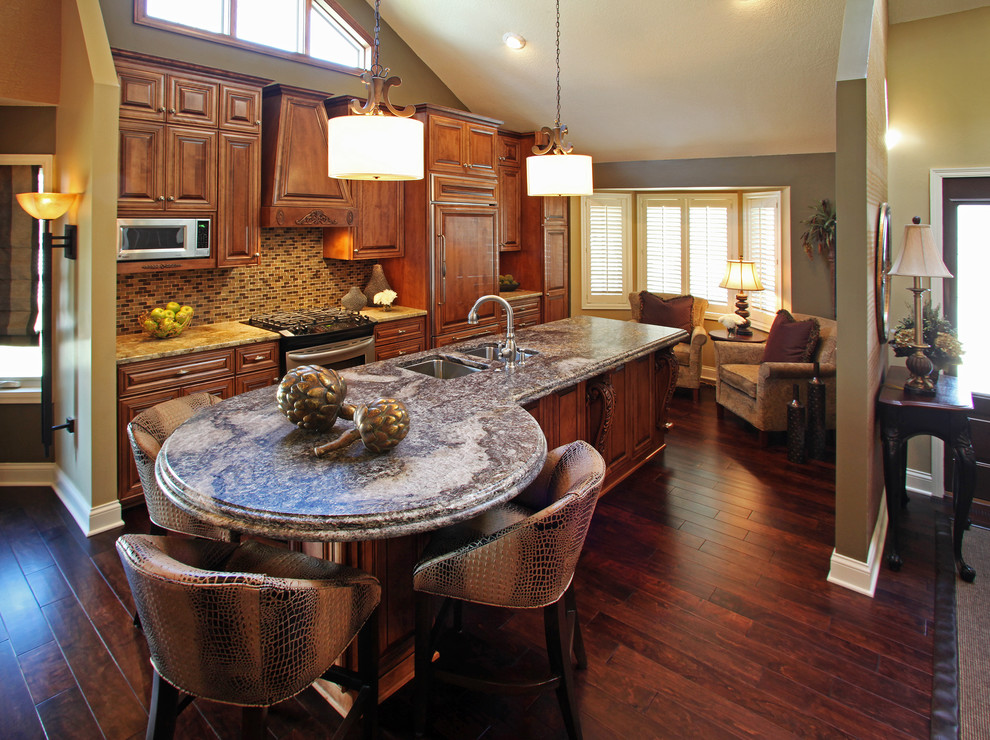 Example of a mid-sized transitional galley dark wood floor eat-in kitchen design in Minneapolis with a double-bowl sink, beaded inset cabinets, medium tone wood cabinets, granite countertops, brown backsplash, stainless steel appliances, an island and mosaic tile backsplash