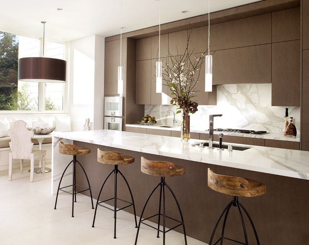 Trendy galley kitchen photo in San Francisco with an undermount sink, flat-panel cabinets, dark wood cabinets, marble countertops, white backsplash, stone slab backsplash, stainless steel appliances and white countertops