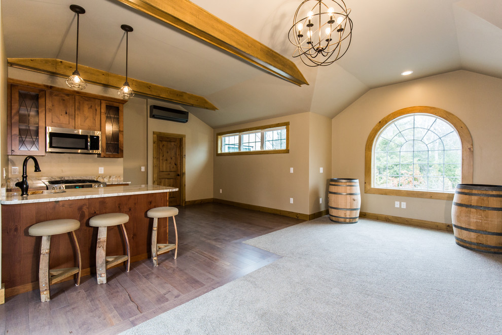 Medium sized rustic u-shaped kitchen/diner in Providence with a submerged sink, shaker cabinets, distressed cabinets, granite worktops, stainless steel appliances, dark hardwood flooring, a breakfast bar and grey floors.