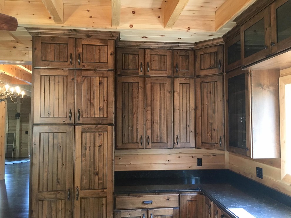 Medium sized rustic l-shaped kitchen in Salt Lake City with shaker cabinets and dark wood cabinets.