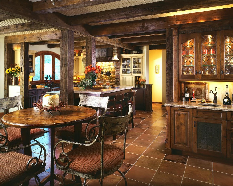 Esempio di una cucina stile rurale di medie dimensioni con lavello sottopiano, ante di vetro, ante bianche, top in granito, paraspruzzi multicolore, paraspruzzi in mattoni, elettrodomestici in acciaio inossidabile, pavimento in terracotta e pavimento marrone