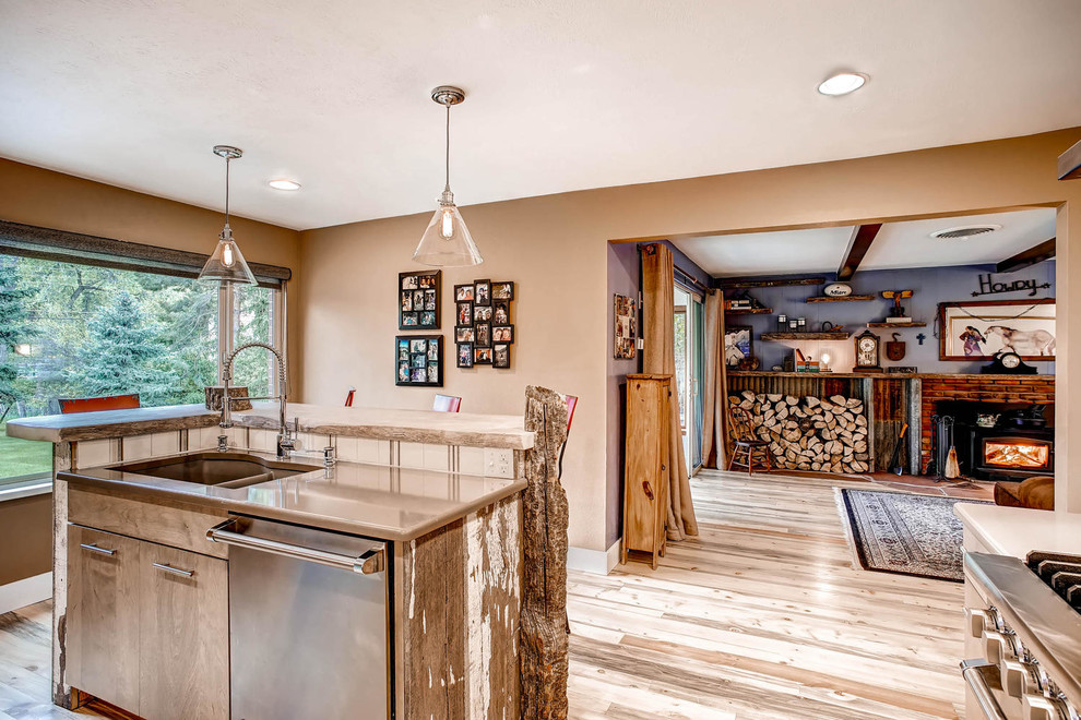 Photo of a large rustic l-shaped kitchen/diner in Denver with a submerged sink, flat-panel cabinets, light wood cabinets, engineered stone countertops, multi-coloured splashback, ceramic splashback, stainless steel appliances, light hardwood flooring and an island.