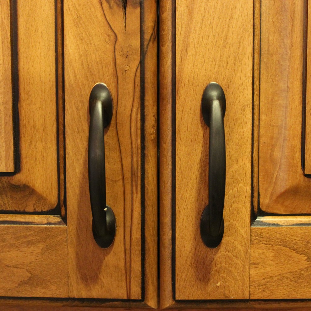 This is an example of a medium sized traditional u-shaped kitchen/diner in Chicago with a submerged sink, raised-panel cabinets, light wood cabinets, granite worktops, black appliances, light hardwood flooring and an island.