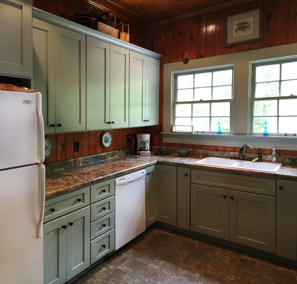 Inspiration for a small rustic u-shaped vinyl floor enclosed kitchen remodel in Atlanta with a drop-in sink, shaker cabinets, green cabinets, laminate countertops, brown backsplash, white appliances and no island