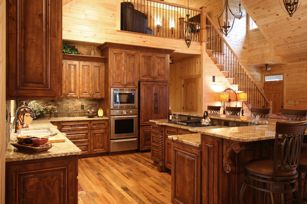 Example of a mountain style kitchen design in Charlotte with granite countertops and slate backsplash