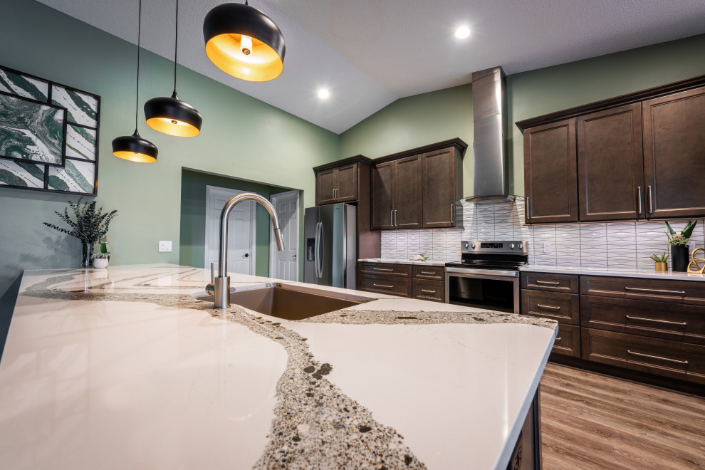 This is an example of an expansive classic single-wall kitchen/diner in Orlando with a submerged sink, recessed-panel cabinets, grey cabinets, engineered stone countertops, white splashback, porcelain splashback, stainless steel appliances, vinyl flooring, an island, grey floors and white worktops.