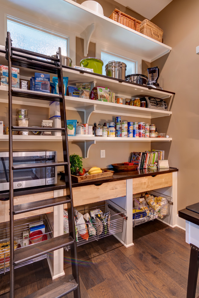 This is an example of a large classic l-shaped kitchen pantry in Indianapolis with a built-in sink, shaker cabinets, beige cabinets, granite worktops, metallic splashback, mosaic tiled splashback, integrated appliances, dark hardwood flooring, an island, brown floors and beige worktops.
