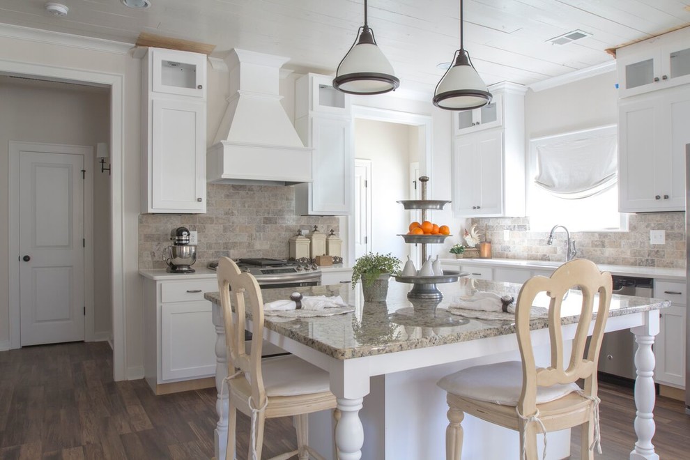Example of a mid-sized country l-shaped dark wood floor and brown floor eat-in kitchen design in Birmingham with an undermount sink, shaker cabinets, white cabinets, granite countertops, multicolored backsplash, stone tile backsplash and an island