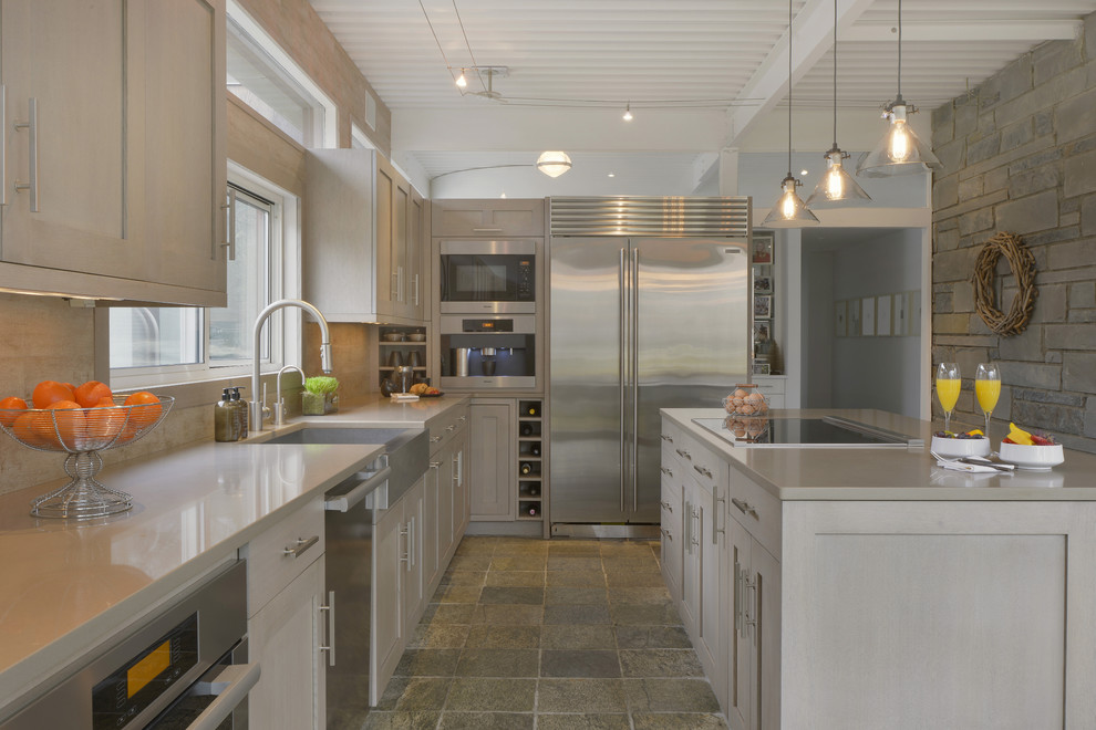 Inspiration for a large coastal l-shaped multicolored floor eat-in kitchen remodel in New York with a farmhouse sink, shaker cabinets, light wood cabinets, quartz countertops, beige backsplash, porcelain backsplash, stainless steel appliances and an island