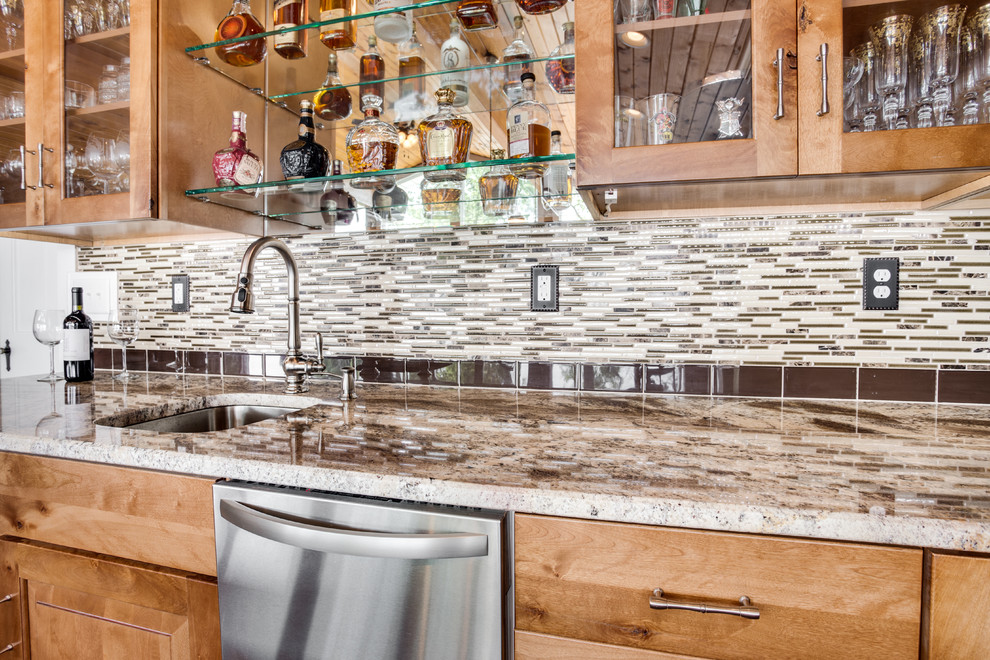 Photo of a large rustic kitchen in DC Metro with a submerged sink, raised-panel cabinets, granite worktops, glass tiled splashback, stainless steel appliances and an island.
