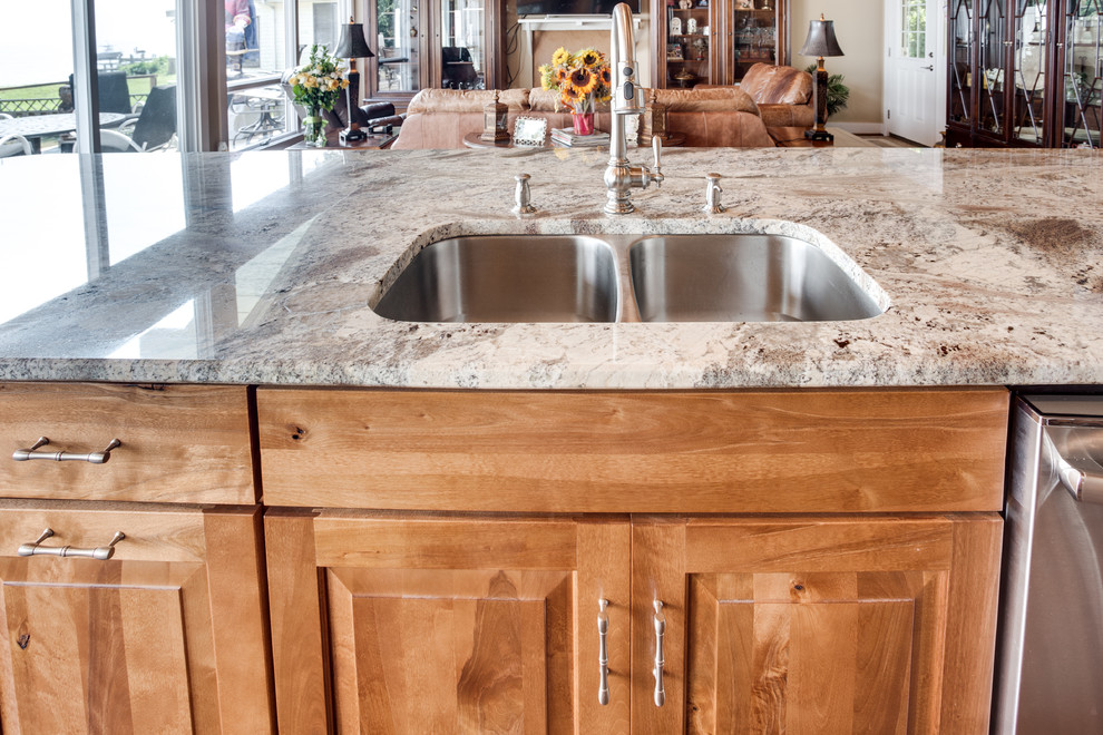 Design ideas for a large rustic kitchen in DC Metro with a submerged sink, raised-panel cabinets, granite worktops, glass tiled splashback, stainless steel appliances and an island.