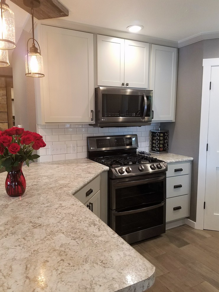 Example of a mid-sized cottage u-shaped open concept kitchen design in Other with a drop-in sink, shaker cabinets, gray cabinets, laminate countertops, white backsplash, subway tile backsplash and a peninsula