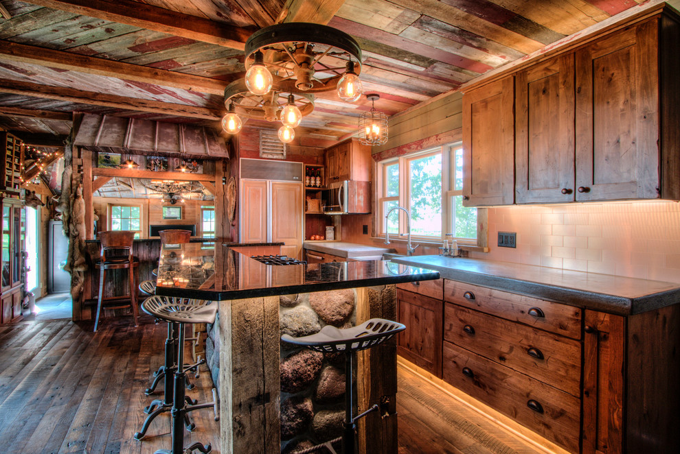 Inspiration for a small rustic galley medium tone wood floor eat-in kitchen remodel in Milwaukee with recessed-panel cabinets, light wood cabinets, an island, a farmhouse sink, concrete countertops, beige backsplash, cement tile backsplash and paneled appliances