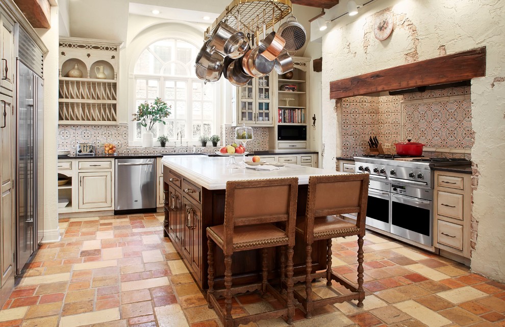 Farmhouse u-shaped enclosed kitchen photo in Chicago with raised-panel cabinets, beige cabinets, multicolored backsplash and stainless steel appliances
