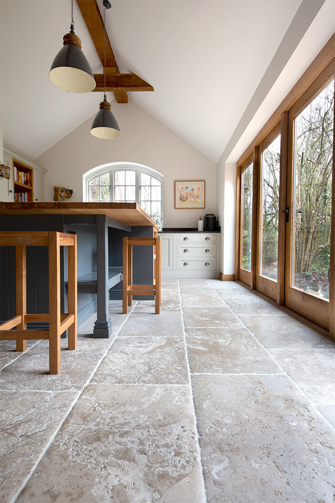Kitchen - mid-sized country limestone floor and beige floor kitchen idea in Other with an island